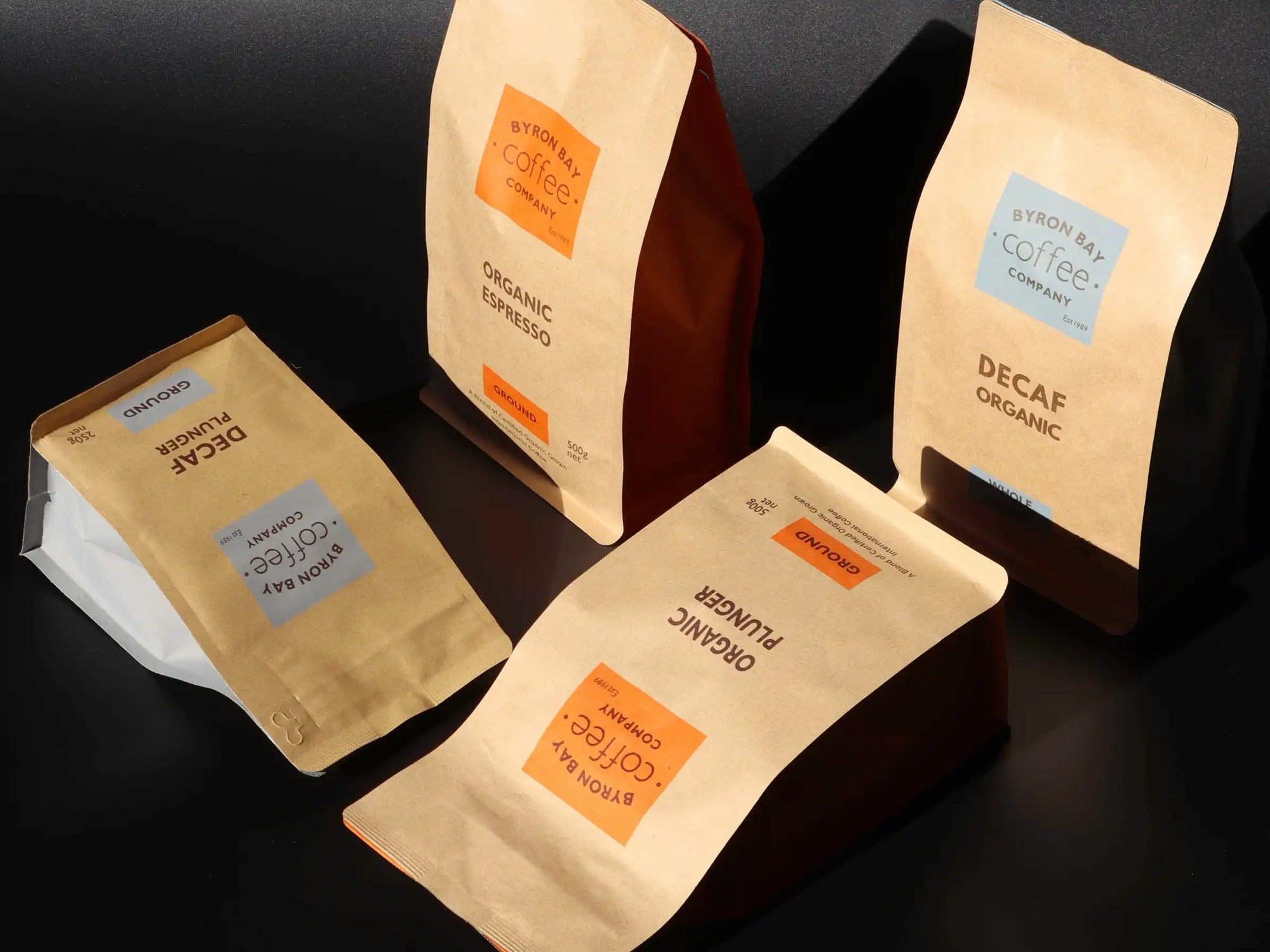 Four bags of organic mycotoxin free coffee on a black background