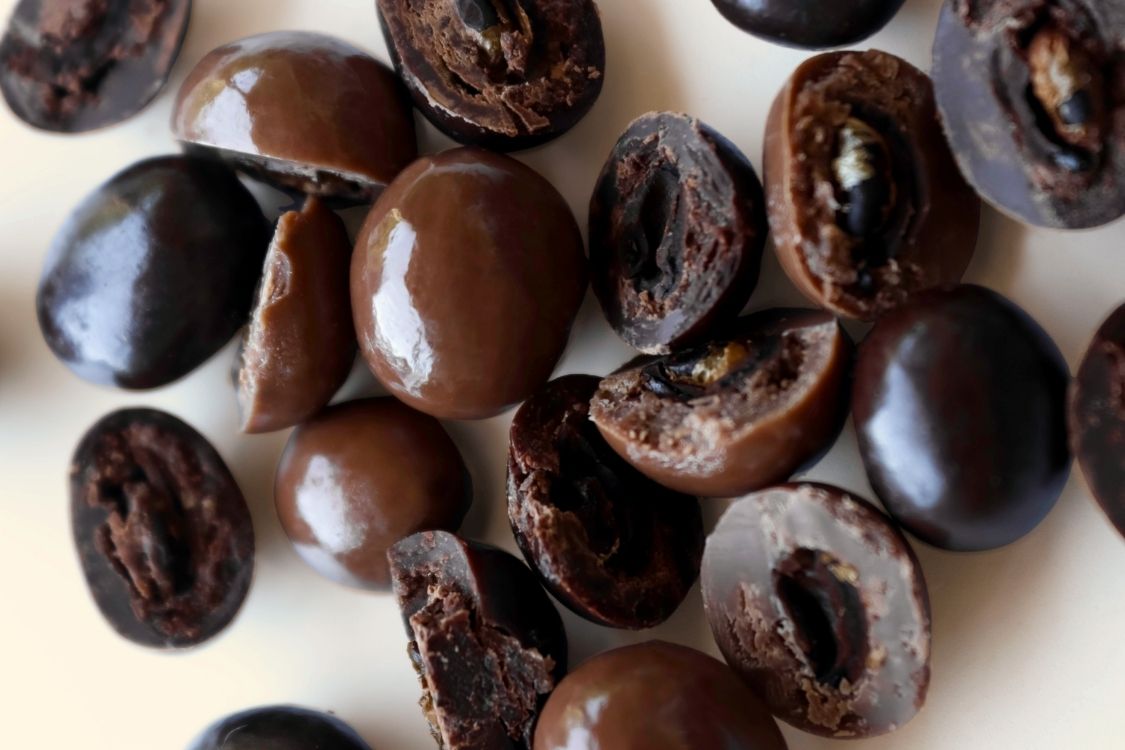Chocolate coated coffee beans on a white background