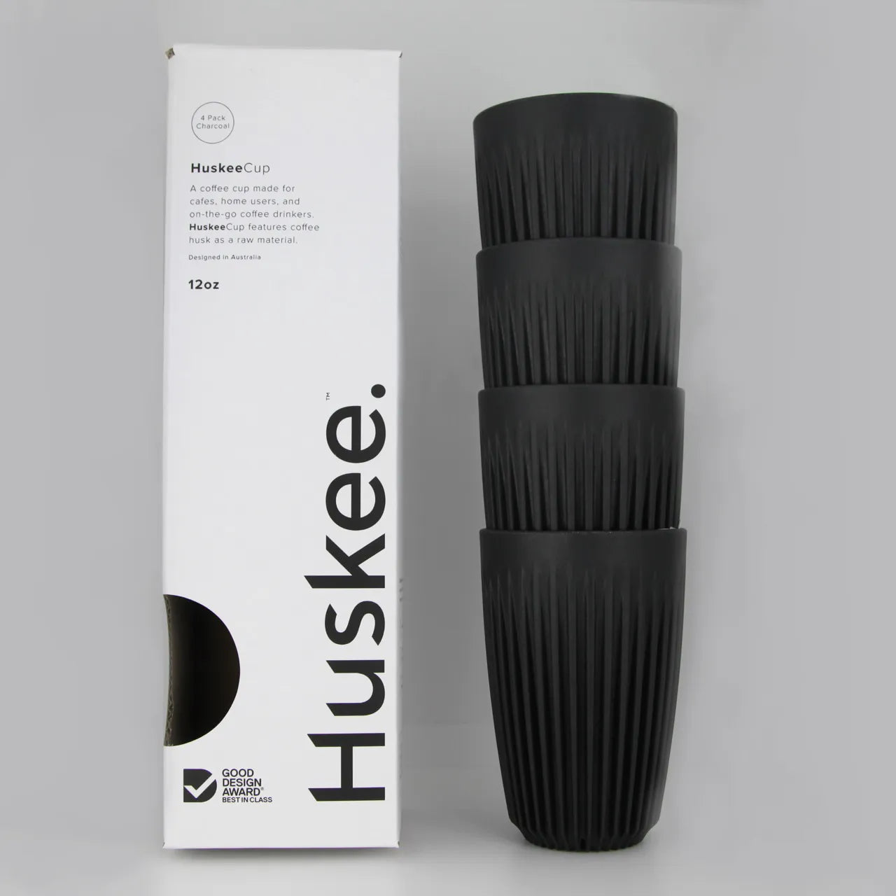 Stack of 4 charcoal coloured Huskee cups with white packaging beside