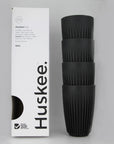 Stack of 4 charcoal coloured Huskee cups with white packaging beside