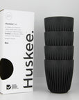 Stack of 4 charcoal coloured Huskee reusable cups