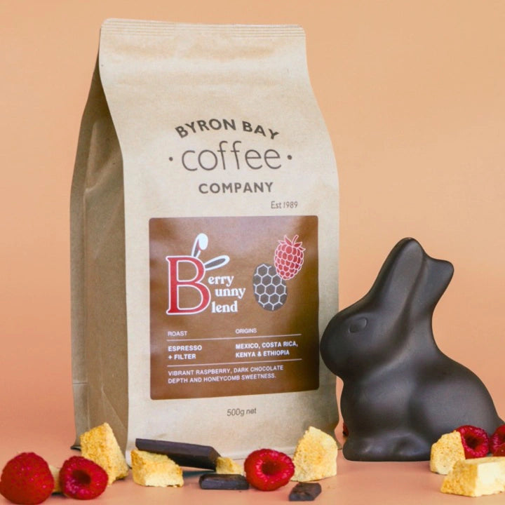 Byron Bay Coffee Company berry bunny blend coffee bag with a chocolate rabbit and berries on a peach background