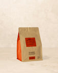 Bag of Classic Plunger coffee with dark chocolate, cinnamon, and brown sugar notes.