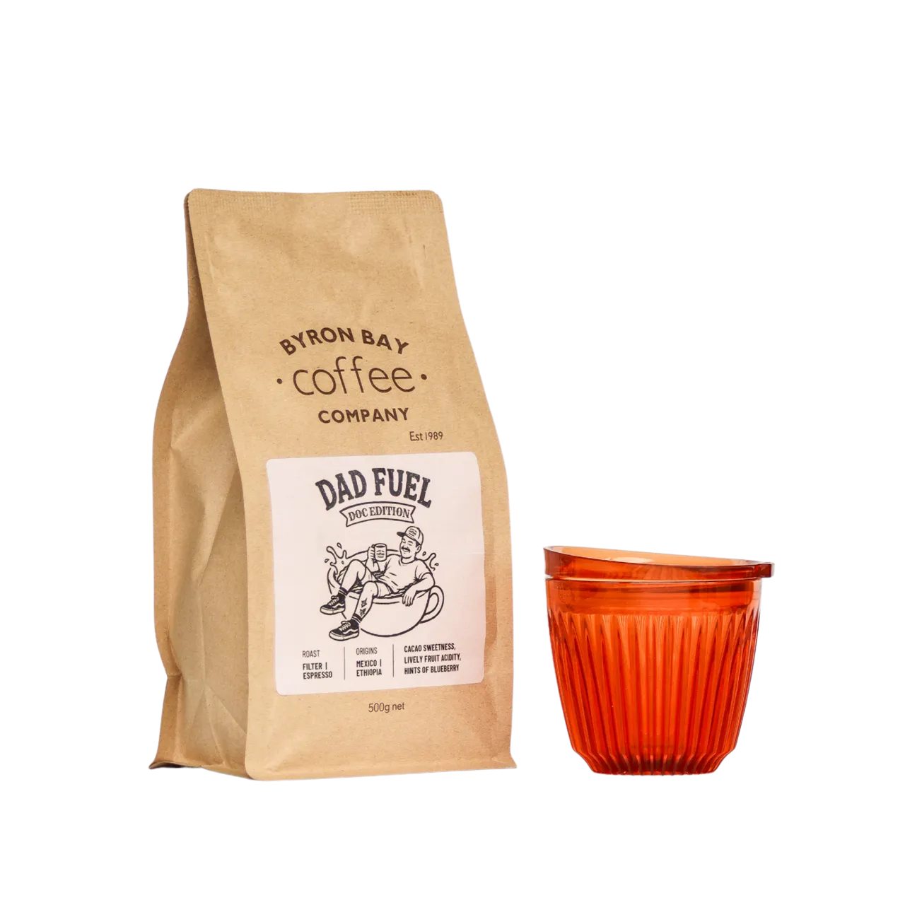 A 500g bag of Dad Fuel coffee next to an Amber Huskee Coffee Cup