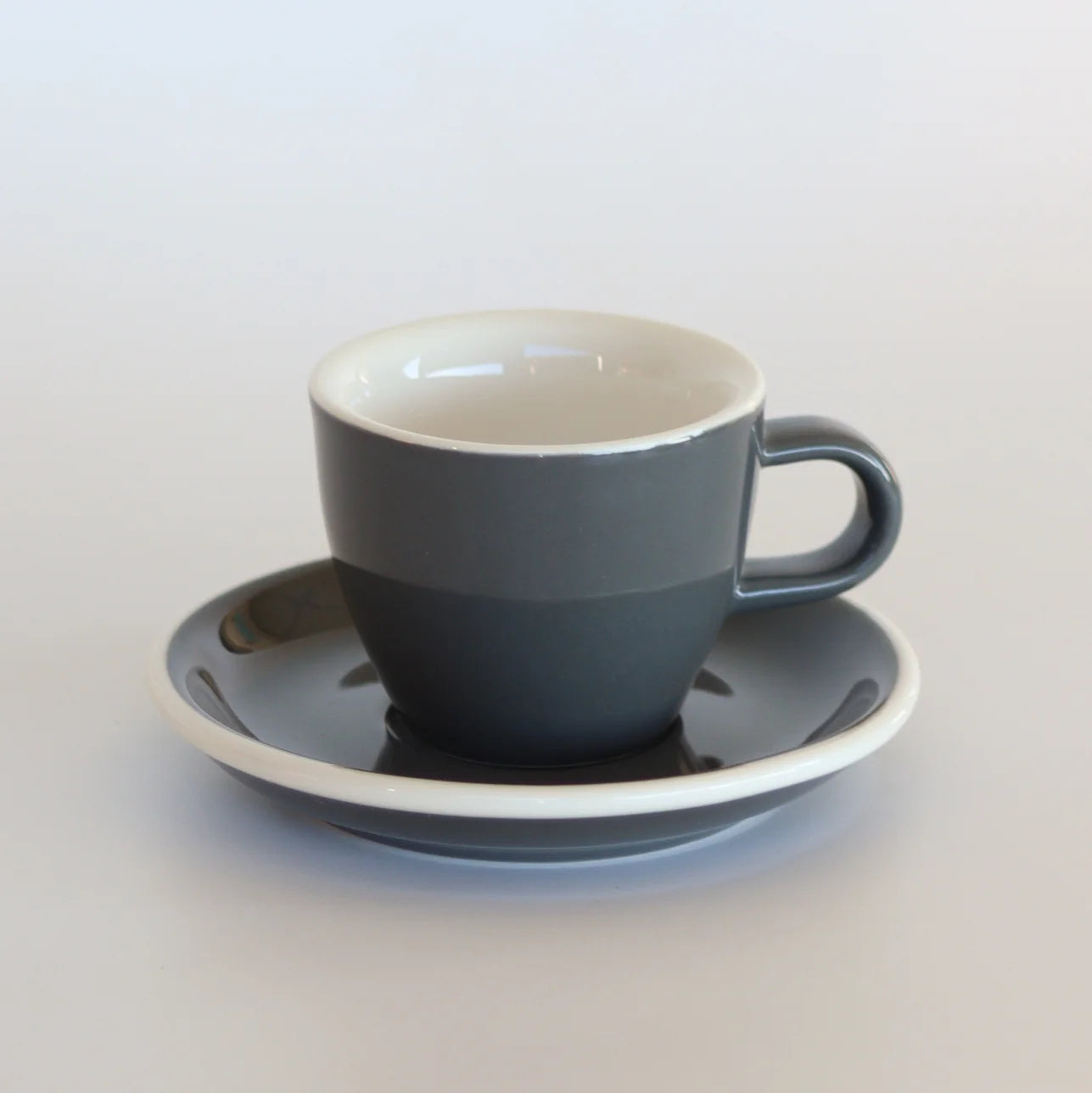 Grey Espresso cup and saucer with white background