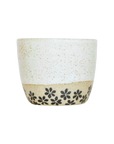 Ceramic coffee cup with floral patterns on a white background