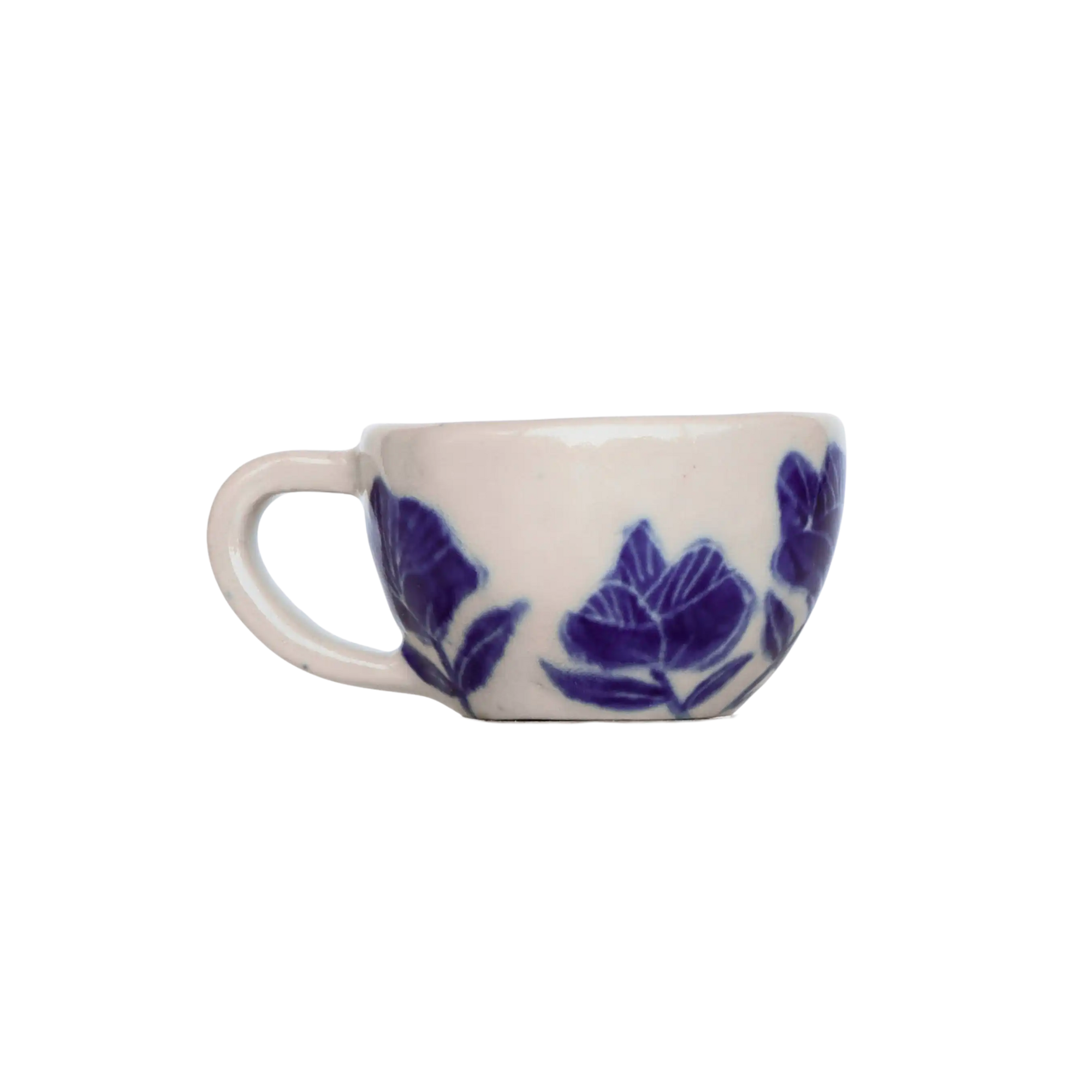 White ceramic cup with blue floral patterns on a white background