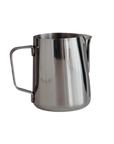 Stainless steel milk jug on a white background
