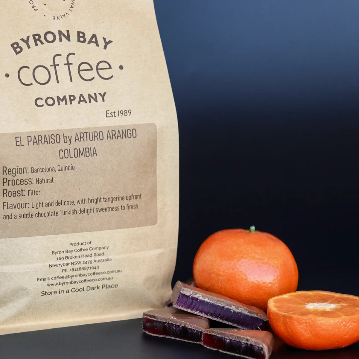 Bag of Colombian single origin coffee for filter next to tangerines and little blocks on Turkish delight