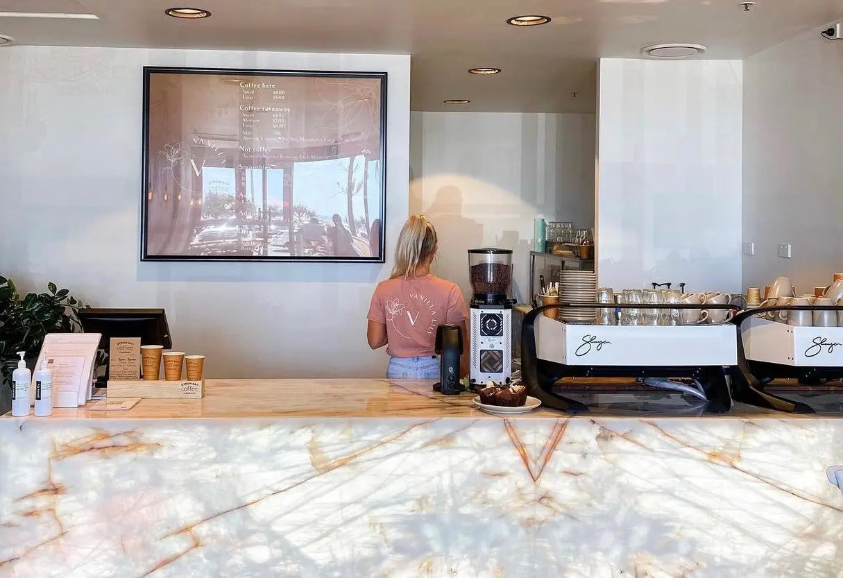 Coffee machines on a counter in a modern cafe with a marble bench