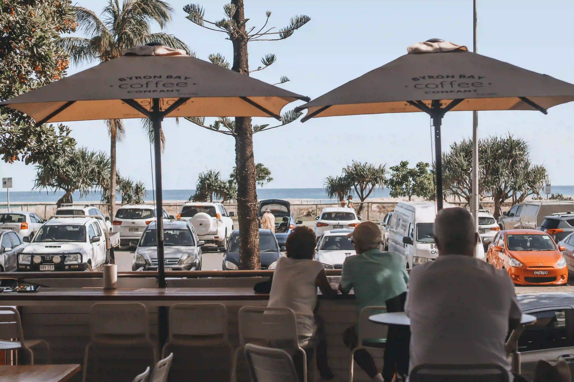People sitting at a beachside cafe with ocean view 