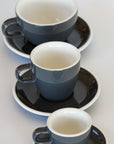 3 sizes of grey ceramic ACME branded cups and saucers